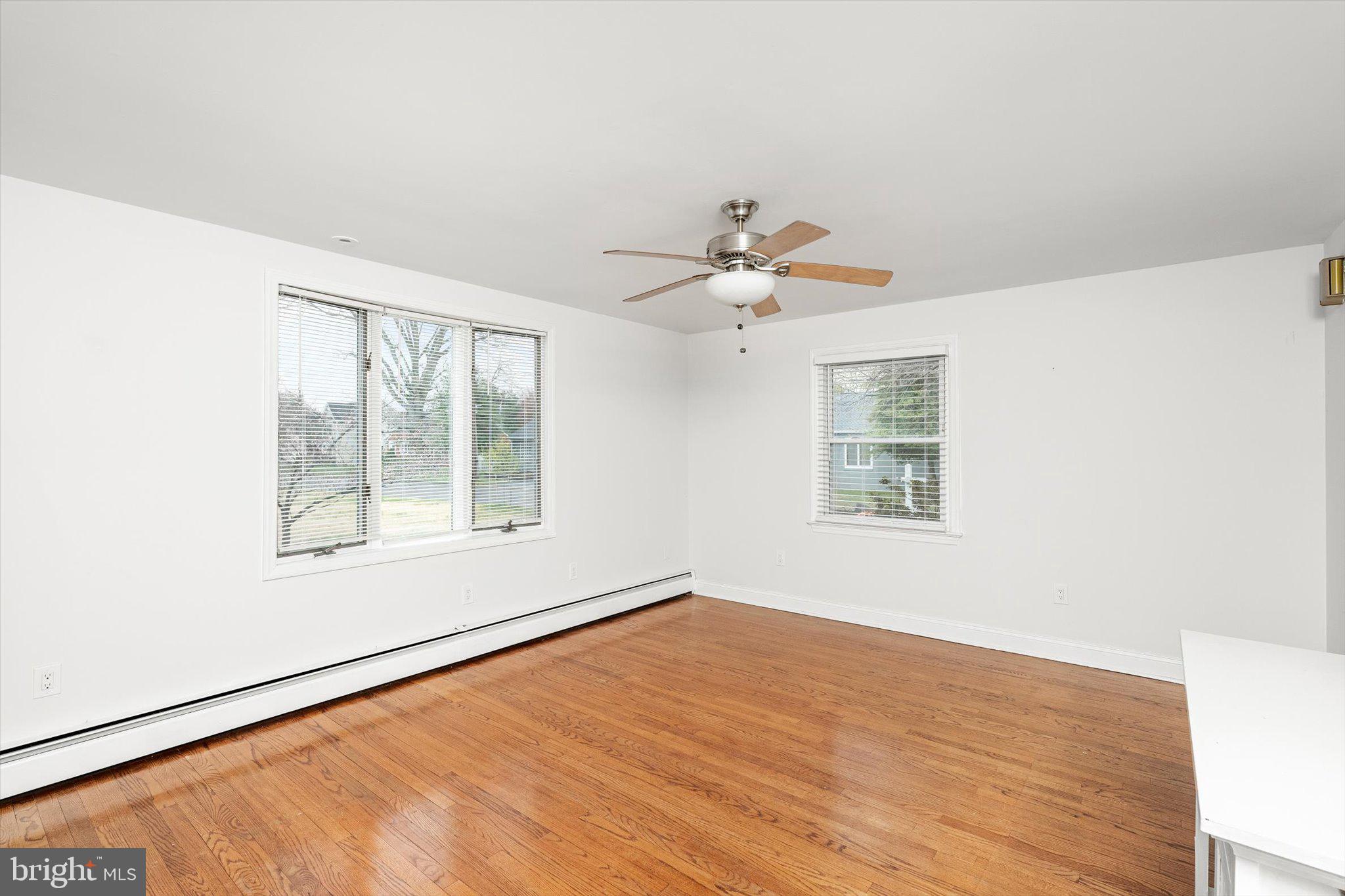 446 Trinity Avenue Hamilton, NJ 08619 - Photo 13 of 31 a view of an empty room with a window and wooden floor
