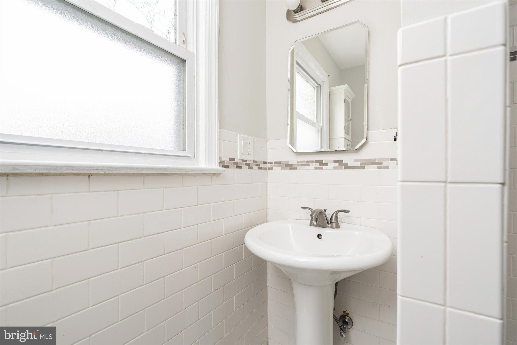 446 Trinity Avenue Hamilton, NJ 08619 - Photo 16 of 31 a bathroom with a sink and a mirror