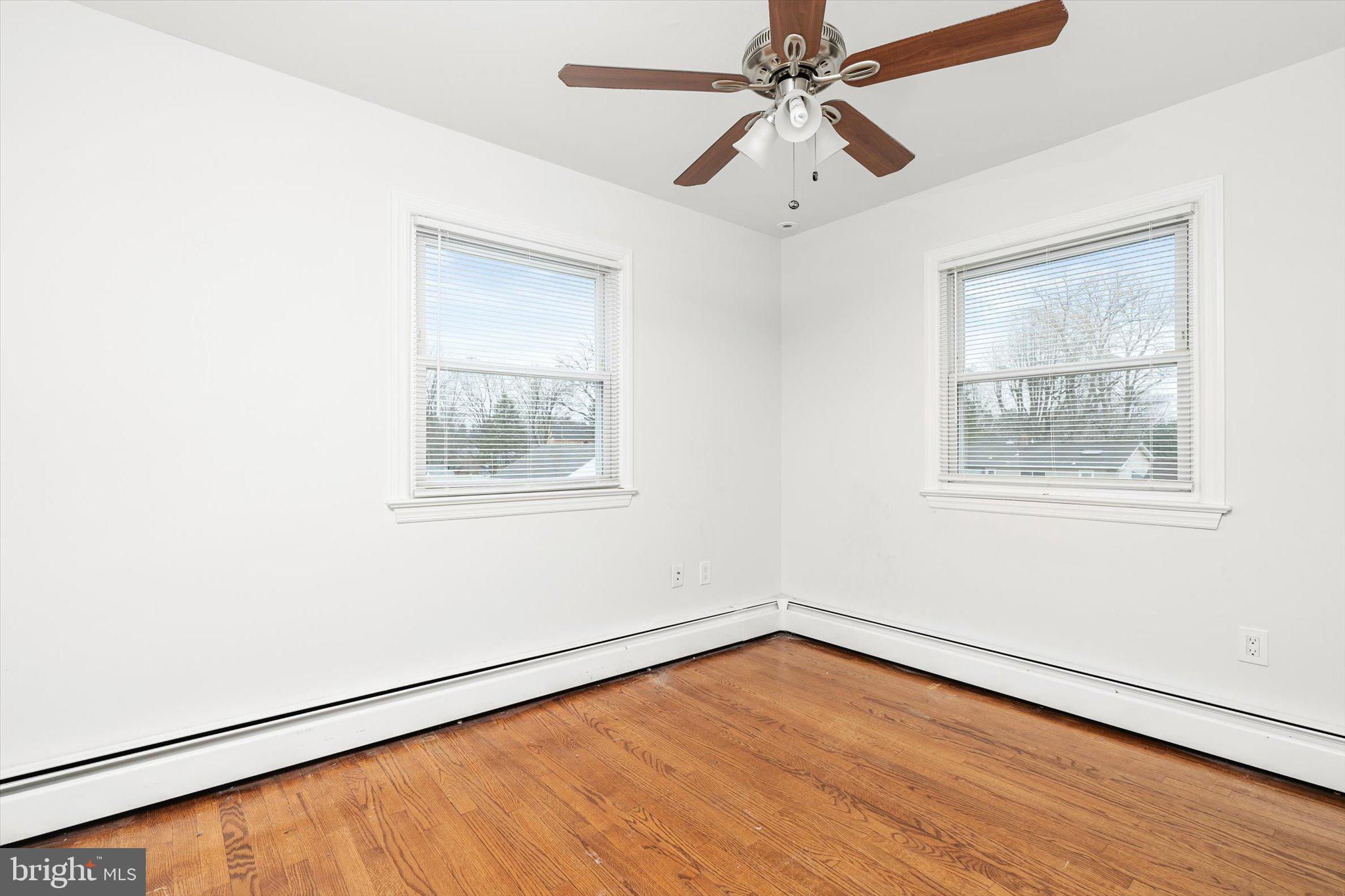 446 Trinity Avenue Hamilton, NJ 08619 - Photo 19 of 31 a view of an empty room with wooden floor and a window