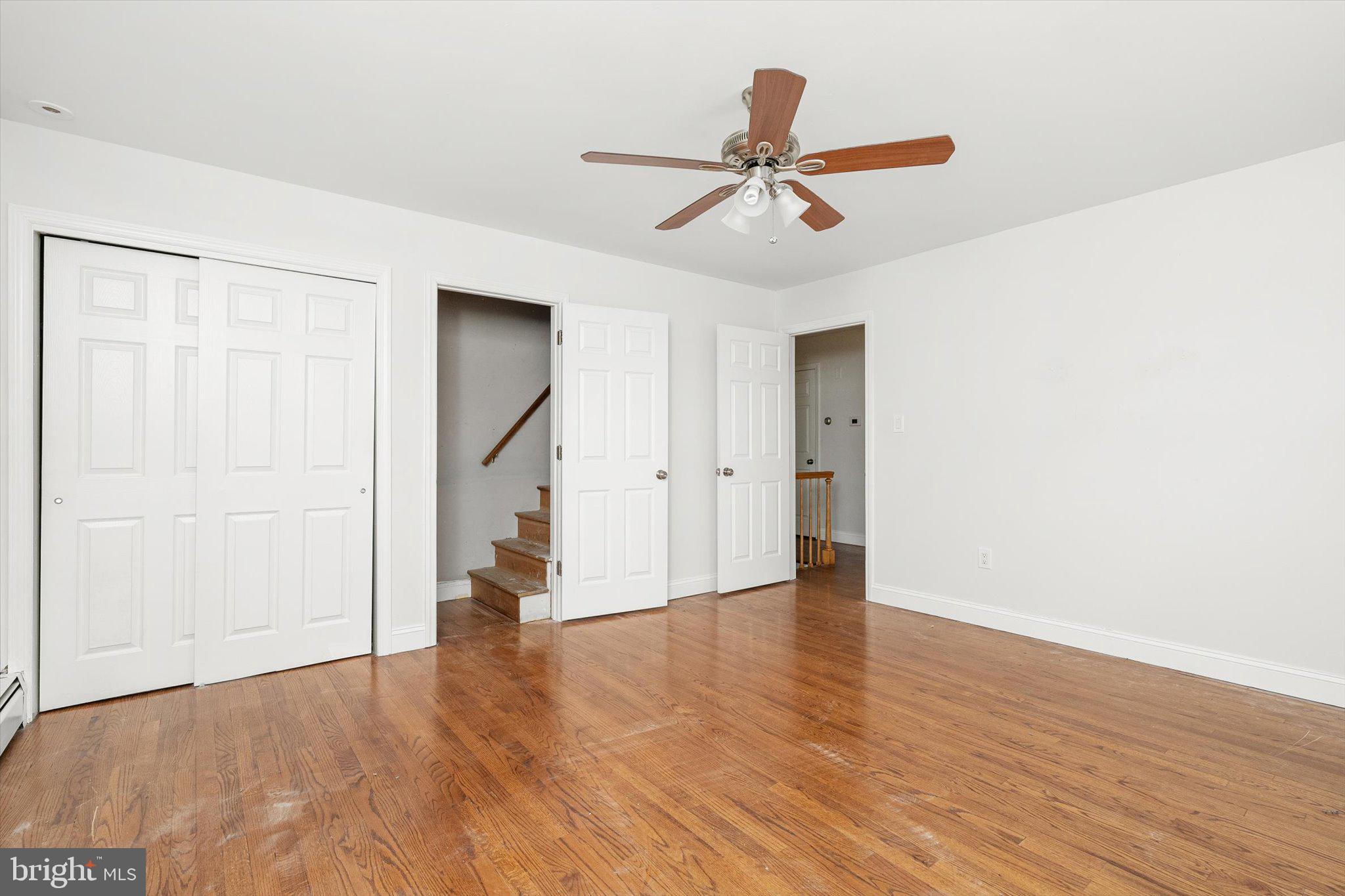 446 Trinity Avenue Hamilton, NJ 08619 - Photo 20 of 31 a view of an empty room with wooden floor and a ceiling fan
