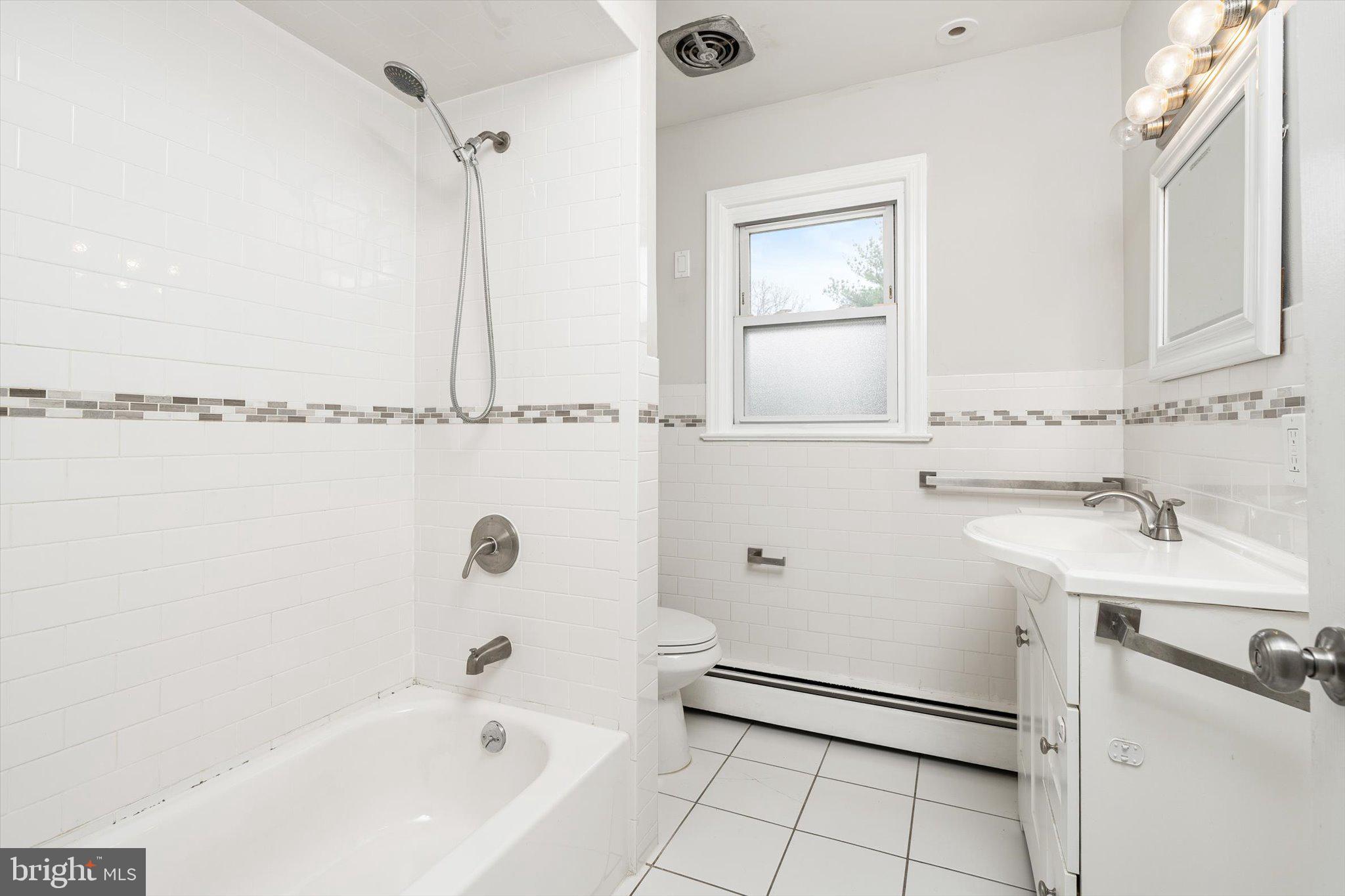 446 Trinity Avenue Hamilton, NJ 08619 - Photo 21 of 31 a bathroom with a sink a toilet and shower