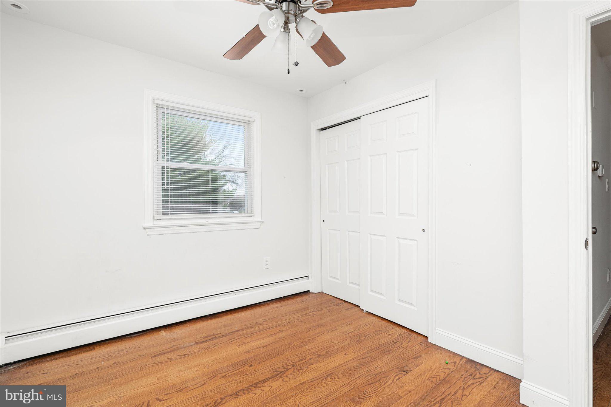 446 Trinity Avenue Hamilton, NJ 08619 - Photo 22 of 31 a view of empty room with wooden floor and fan