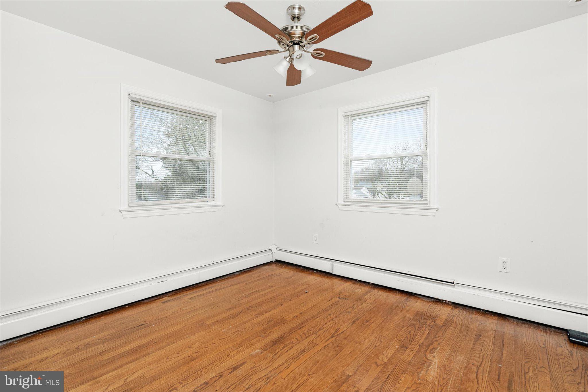 446 Trinity Avenue Hamilton, NJ 08619 - Photo 23 of 31 an empty room with wooden floor ceiling fan and windows