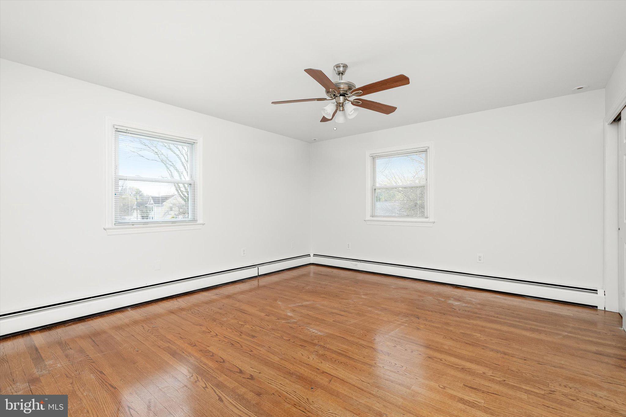 446 Trinity Avenue Hamilton, NJ 08619 - Photo 24 of 31 an empty room with wooden floor and windows