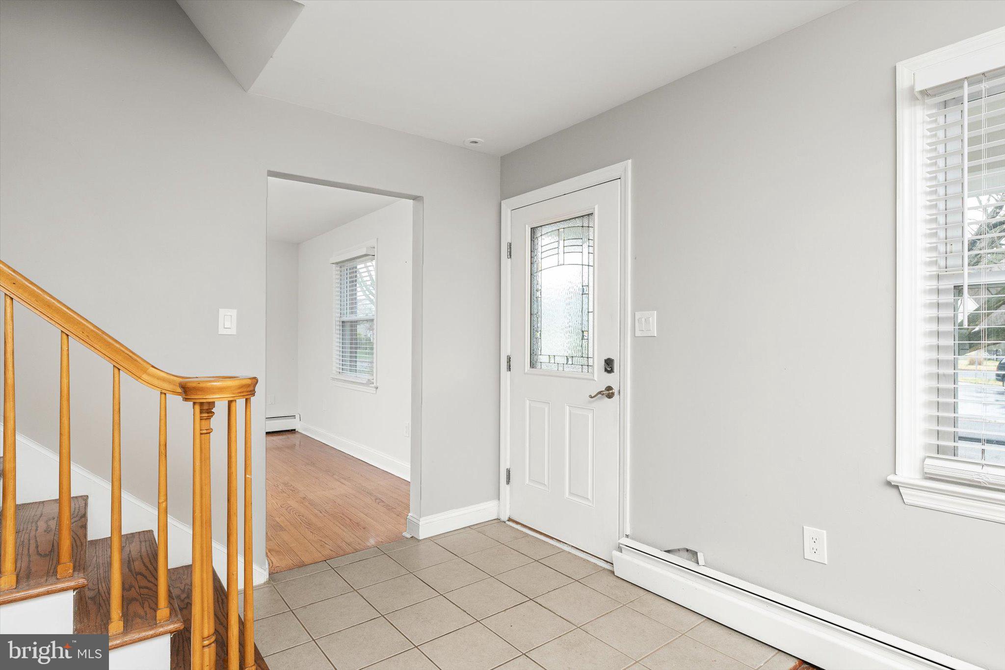 446 Trinity Avenue Hamilton, NJ 08619 - Photo 3 of 31 a view of a hallway with wooden floor and windows