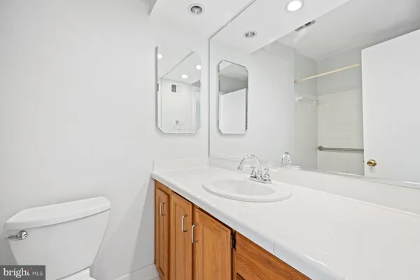 a bathroom with a sink a toilet and a mirror