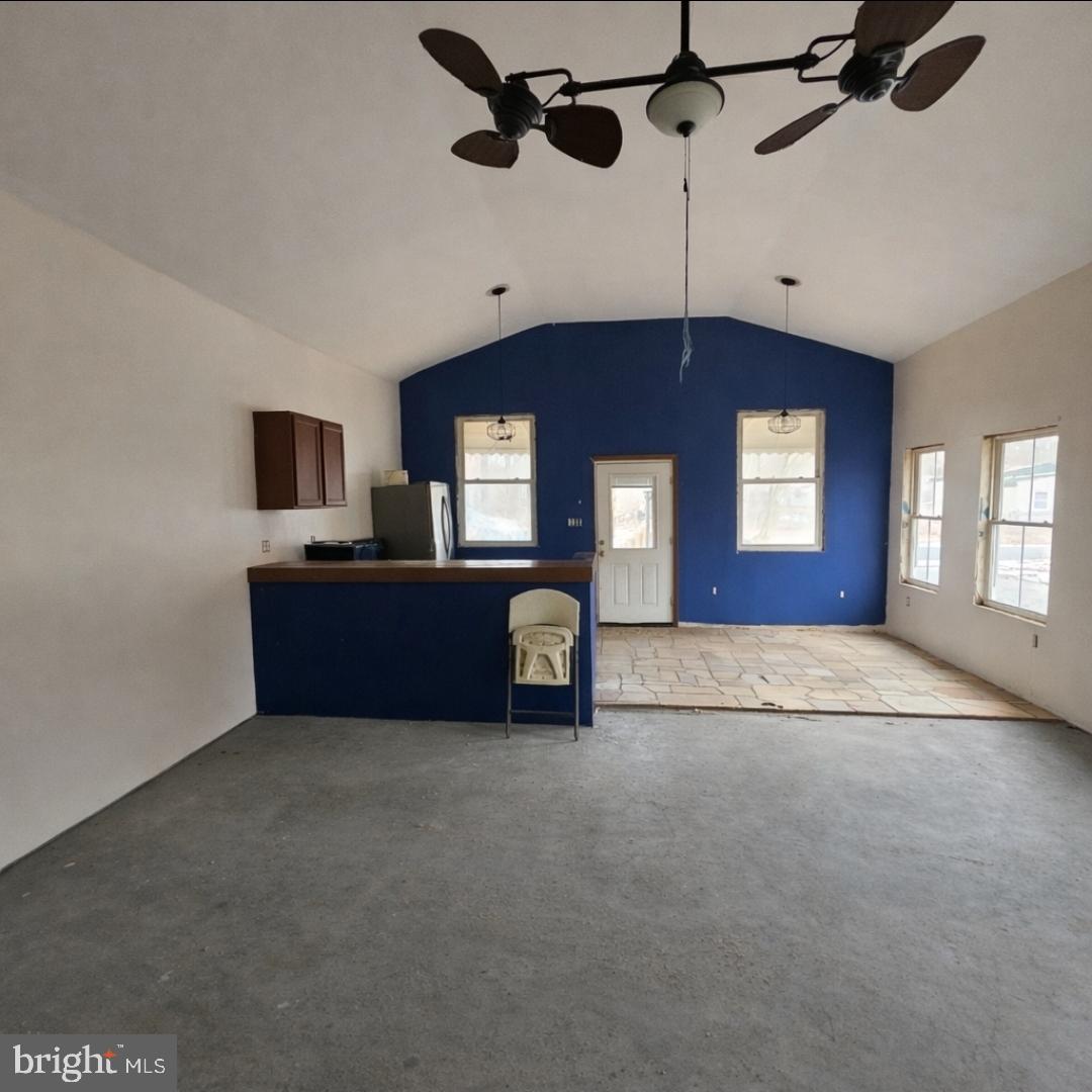 345 Jute Road Millville, NJ 08332 - Photo 14 of 18 a view of a livingroom with a fireplace furniture and a ceiling fan