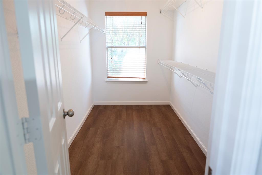 8805 Graywolf Ridge Trail Fort Worth, TX 76244 - Photo 12 of 23 Closet space featuring wood-finish flooring, white walls, and a window with blinds