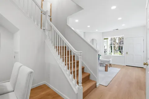 a view of entryway and hall with wooden floor