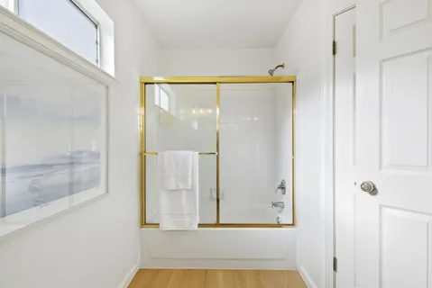 a bathroom with a tub and shower