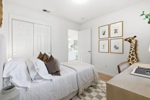 a bedroom with a bed and wooden floor