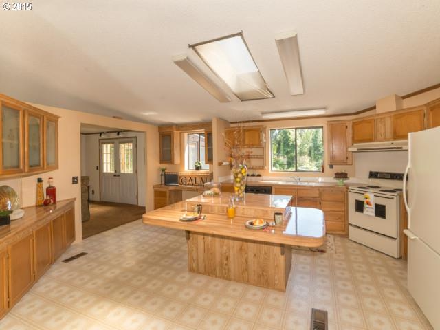 39378 Jasper Lowell Road Lowell, OR 97452 - Photo 6 of 16 a large white kitchen with a large window