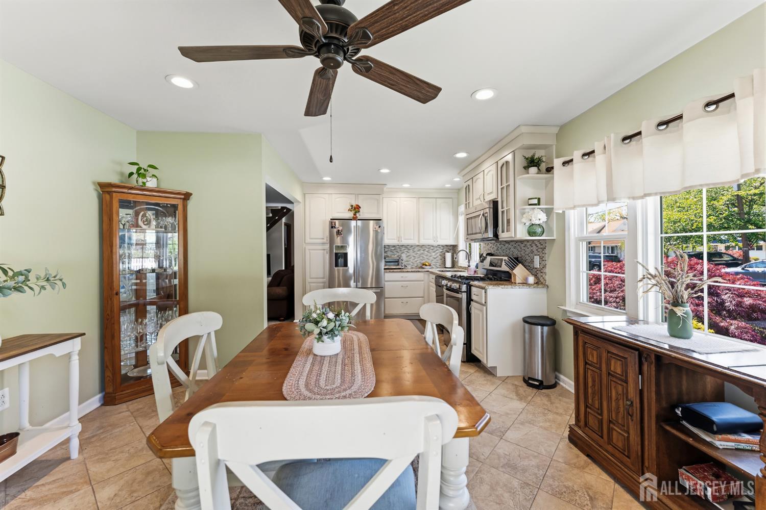 14 Sunrise Road Old Bridge, NJ 08857 - Photo 14 of 32 a kitchen with stainless steel appliances kitchen island granite countertop a refrigerator a stove a sink dishwasher a dining table and chairs with wooden floor