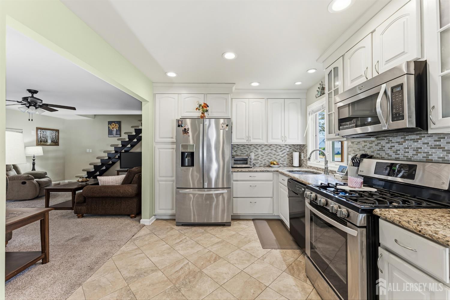 14 Sunrise Road Old Bridge, NJ 08857 - Photo 15 of 32 a kitchen with stainless steel appliances granite countertop a refrigerator stove and microwave