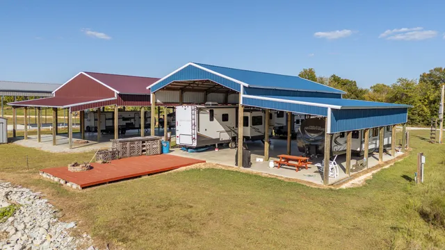 a view of pool with table and chairs under an umbrella