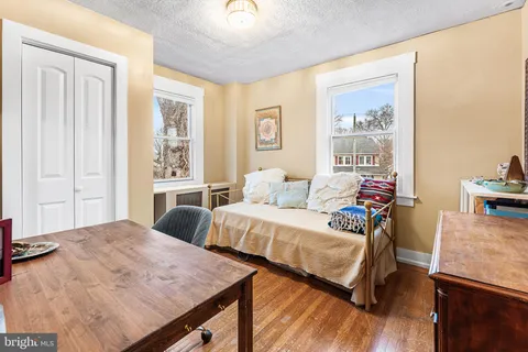 a bedroom with two beds and a table