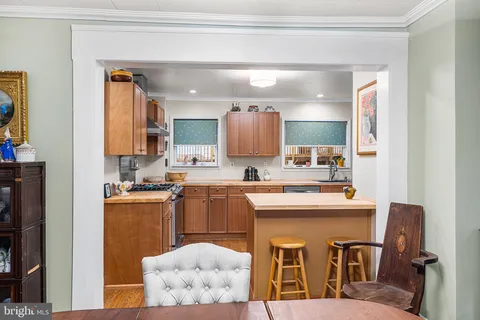 a kitchen with a sink a stove and cabinets