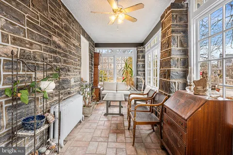 a dining room with furniture and a floor to ceiling window