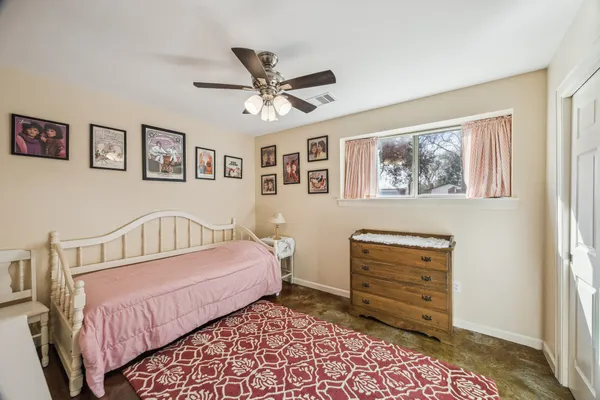 a bedroom with a bed and a dresser