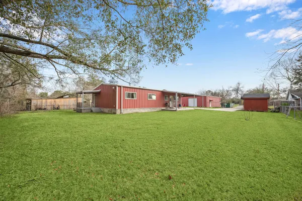 a view of an house with backyard space and balcony