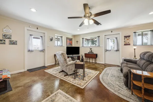 a living room with furniture and a wooden floor