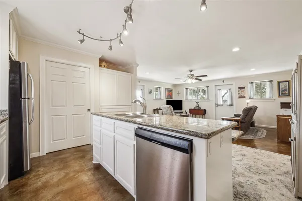 a kitchen with sink stove and refrigerator