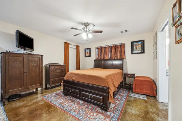 a bedroom with a bed and flat screen tv