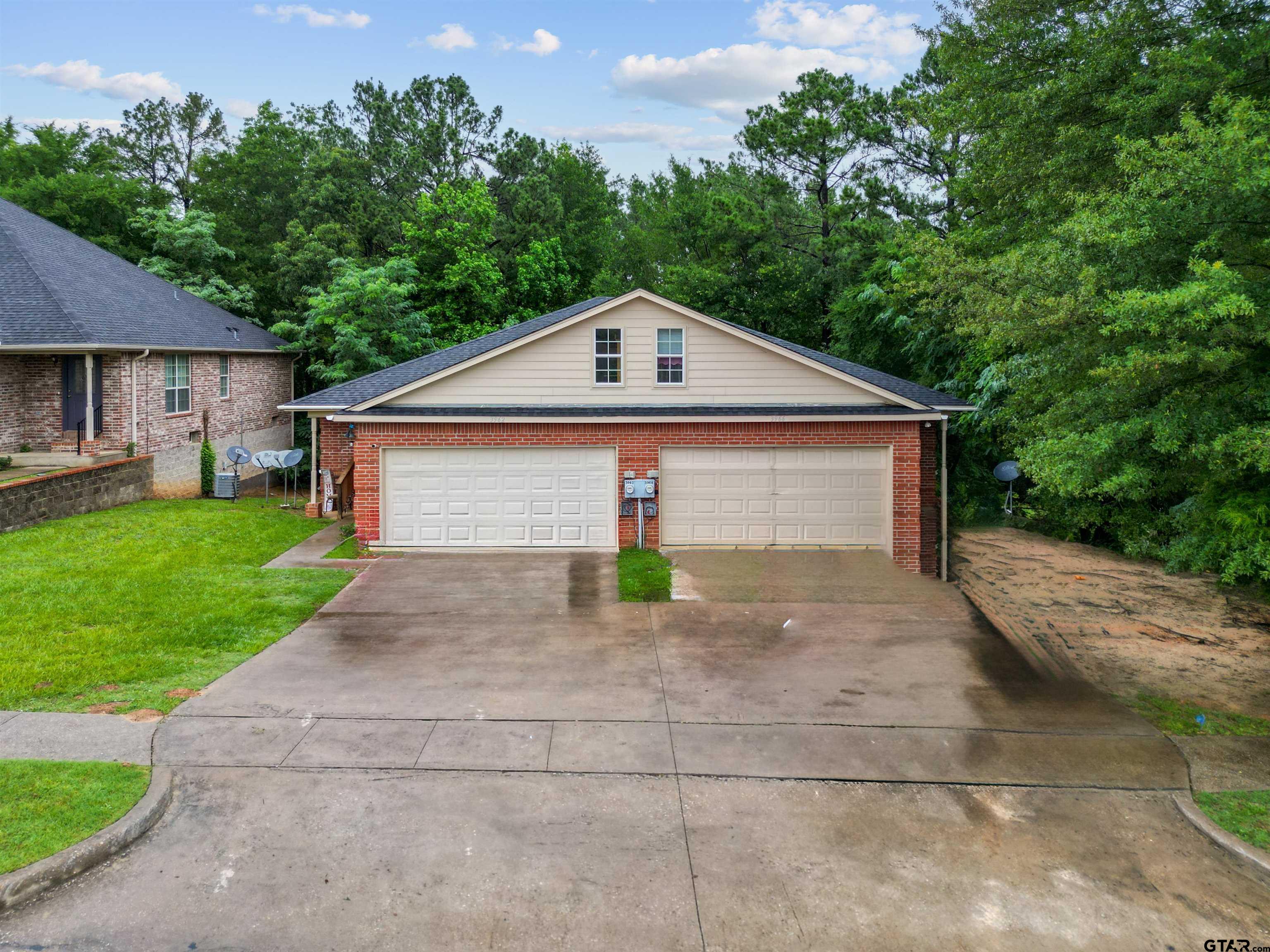 3962-3966 McDonald Road Tyler, TX 75701 - Photo 1 of 5 a view of a house with a yard plants and large tree
