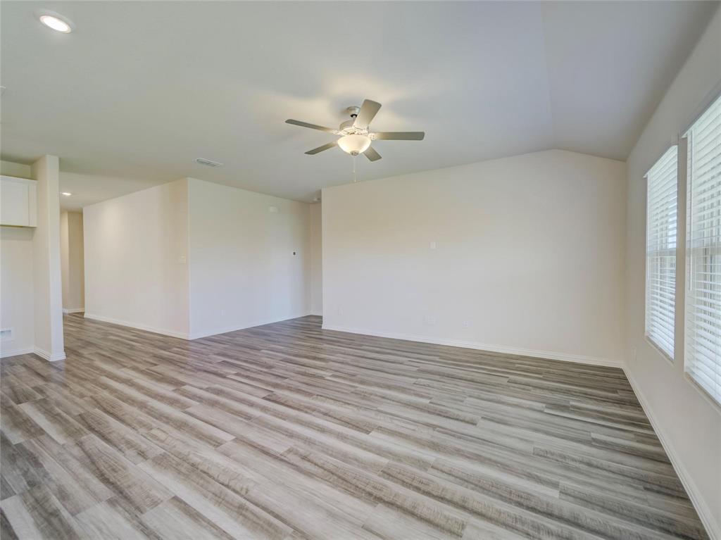 3405 Kingsgarden Road Denton, TX 76207 - Photo 8 of 37 a view of empty room with wooden floor and fan