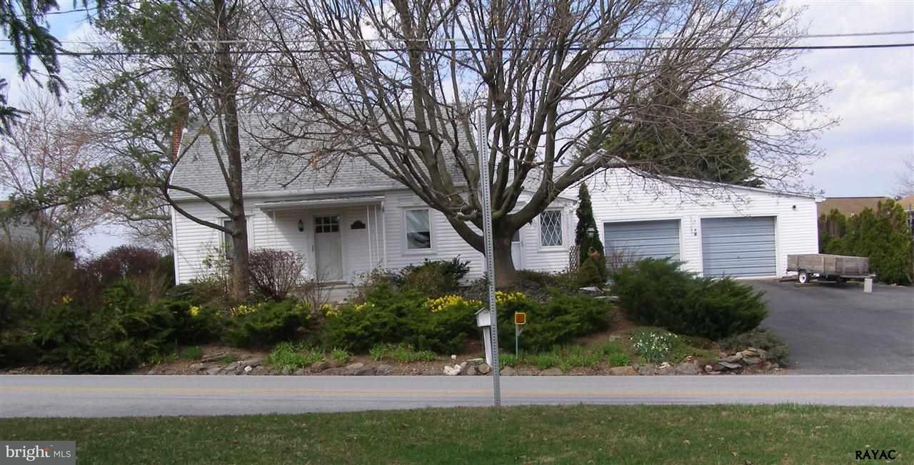 881 Pine Grove Road Hanover, PA 17331 - Photo 1 of 35 a view of a white house next to a yard with potted plants and trees