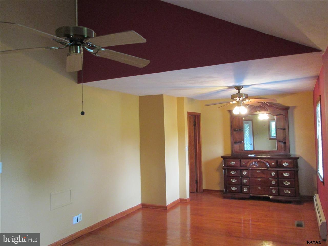 881 Pine Grove Road Hanover, PA 17331 - Photo 27 of 35 an empty room with a mirror and a ceiling fan