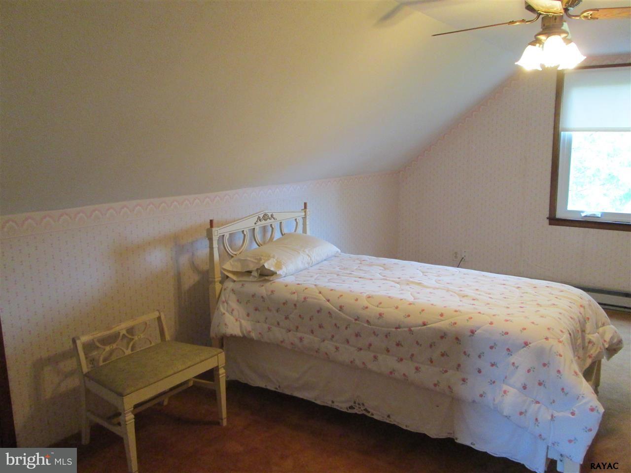 881 Pine Grove Road Hanover, PA 17331 - Photo 29 of 35 a bedroom with a bed and a chair