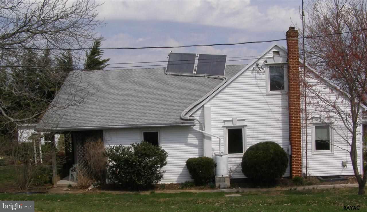 881 Pine Grove Road Hanover, PA 17331 - Photo 8 of 35 a view of a white house with large windows and a yard