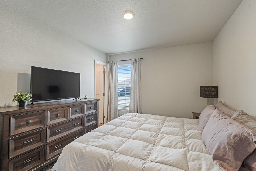 103 Donegal Street Sinton, TX 78387 - Photo 13 of 29 a bedroom with a bed and a flat screen tv