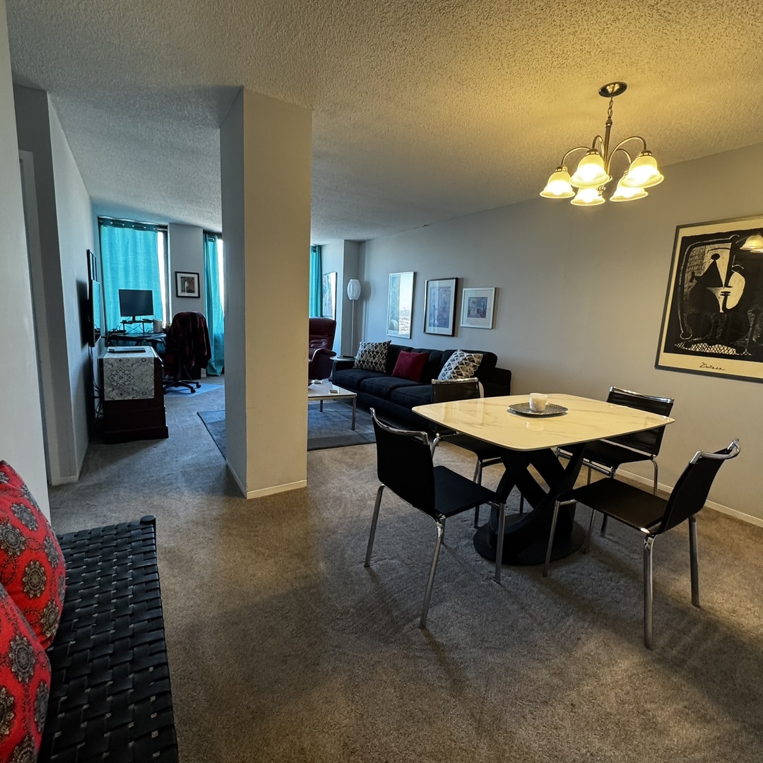 5320 North Sheridan Road, Unit 2001 Chicago, IL 60640 - Photo 6 of 14 a view of a dining room with furniture