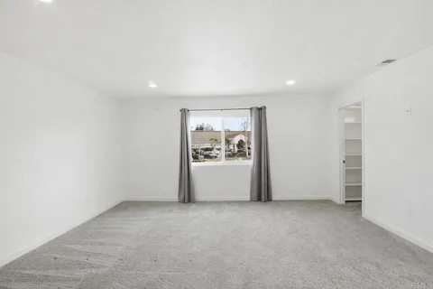 a view of an empty room with a window