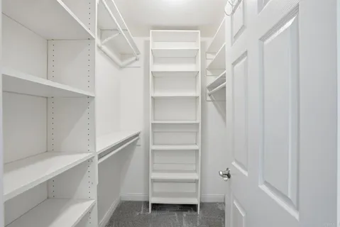 a view of walk in closet with empty racks