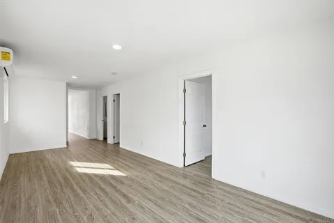 a view of an empty room and wooden floor