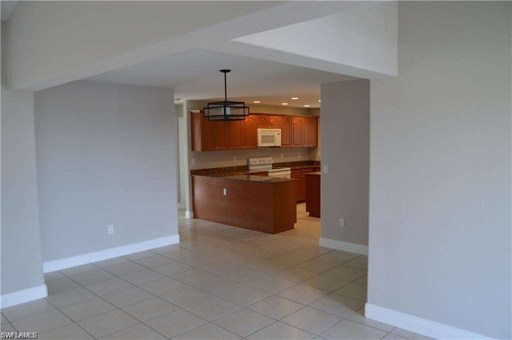 4209 30th Street Southwest Lehigh Acres, FL 33976 - Photo 7 of 13 a kitchen with stainless steel appliances a refrigerator and a stove