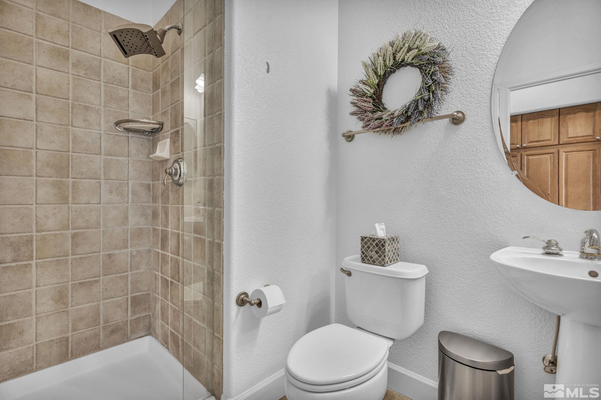 5544 New Mexico Court Reno, NV 89511 - Photo 15 of 39 a bathroom with a toilet a sink and mirror