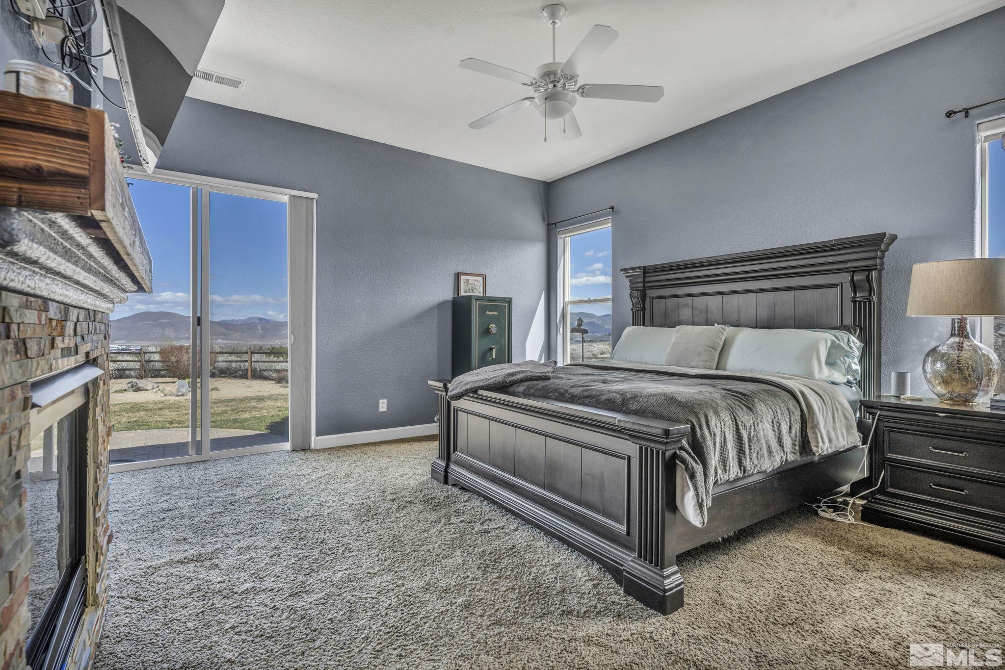 5544 New Mexico Court Reno, NV 89511 - Photo 21 of 39 a spacious bedroom with a bed and a chandelier