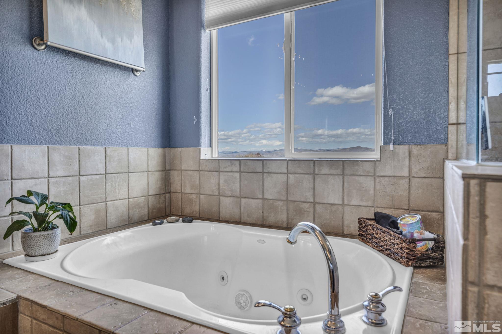 5544 New Mexico Court Reno, NV 89511 - Photo 25 of 39 a white bath tub sitting in a bathroom