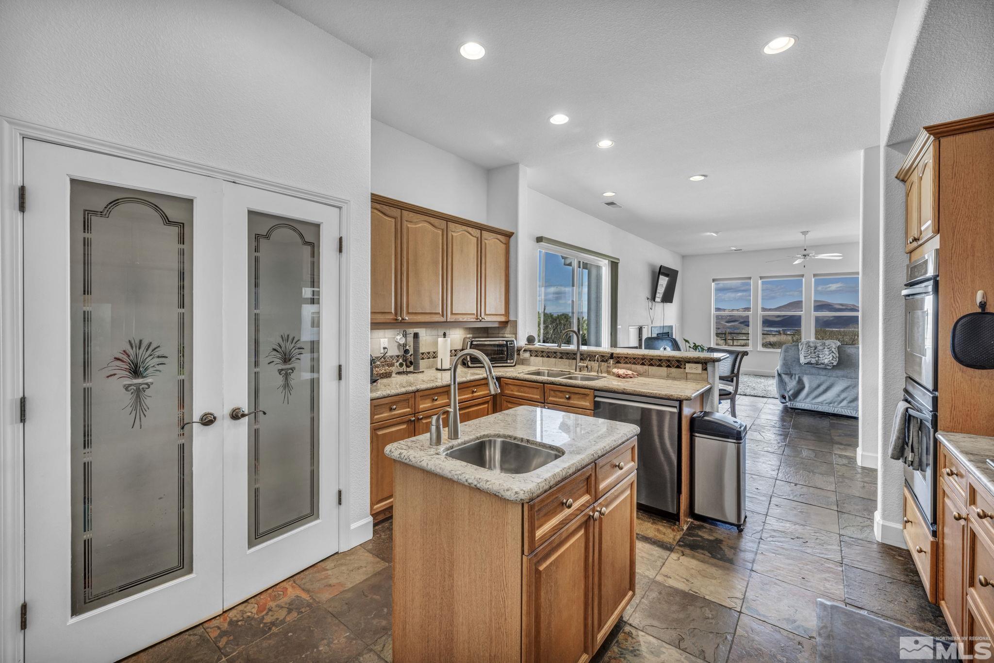 5544 New Mexico Court Reno, NV 89511 - Photo 5 of 39 a kitchen with a sink stove and refrigerator