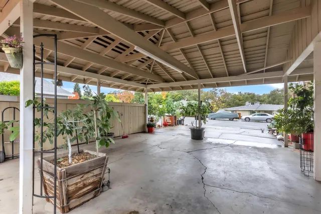 a view of a porch with furniture and a garage