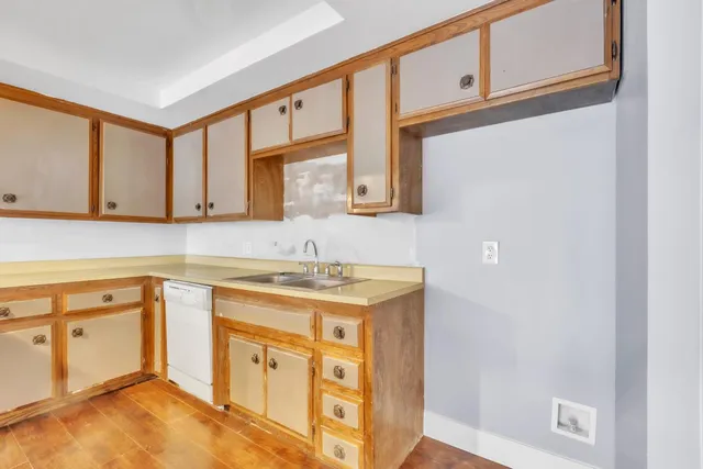 a kitchen with stainless steel appliances granite countertop a sink stove and cabinets