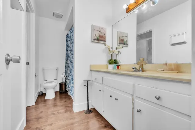 a bathroom with a double vanity sink toilet and shower