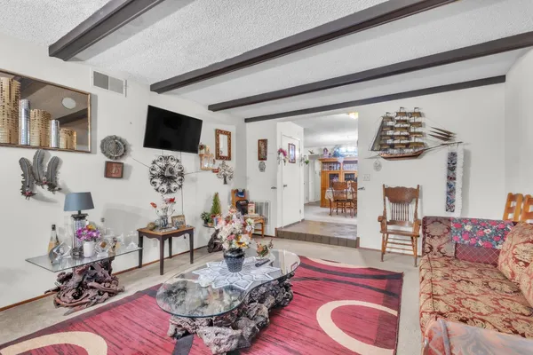 a living room with furniture and flat screen tv