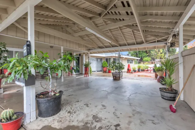 a view of a porch with potted plants