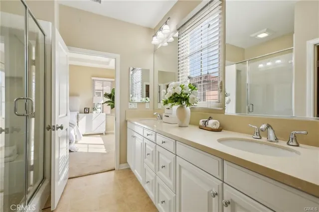 a spacious bathroom with a granite countertop sink mirror and shower