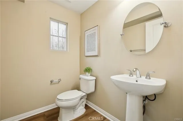 a bathroom with a sink toilet and a mirror